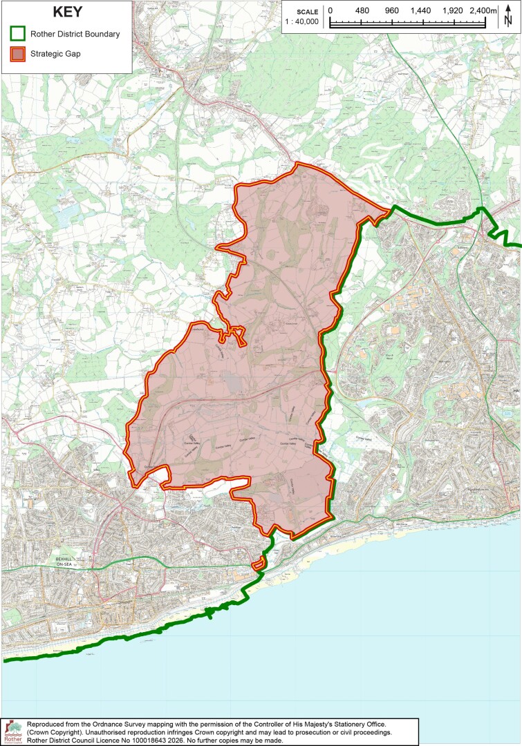 Map showing Rother District boundary and designated Strategic Gap across a coastal urban and rural area. Green line marks district boundary, while red outline and shading identify Strategic Gap; scale bar and north arrow provide geographic reference.