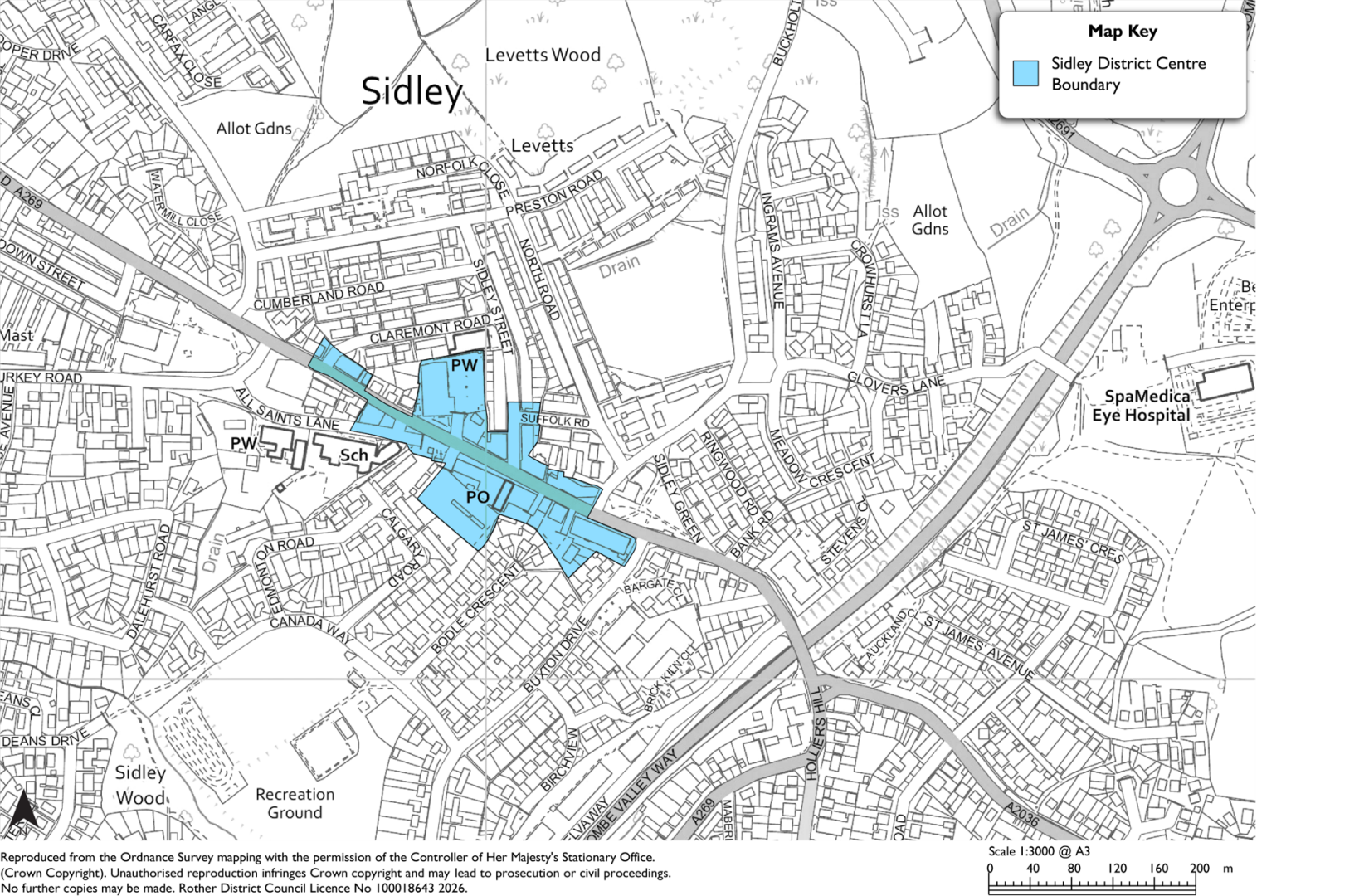 Map showing Sidley area street layout, property boundaries, roads, and labeled landmarks, with a north arrow and scale bar. Bright blue shading marks a proposed site or highlighted development area spanning several connected parcels near a main road and railway corridor.
